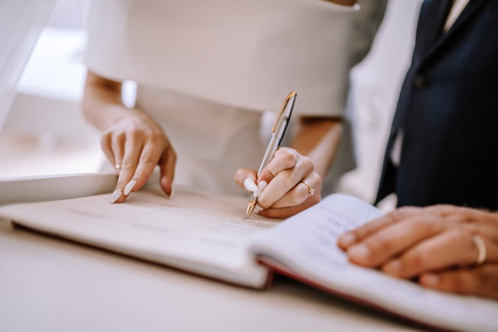 Bride and Groom signing Marriage Certificate