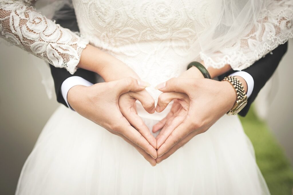 A newlywed couple joining hands and discussing name change options after marriage