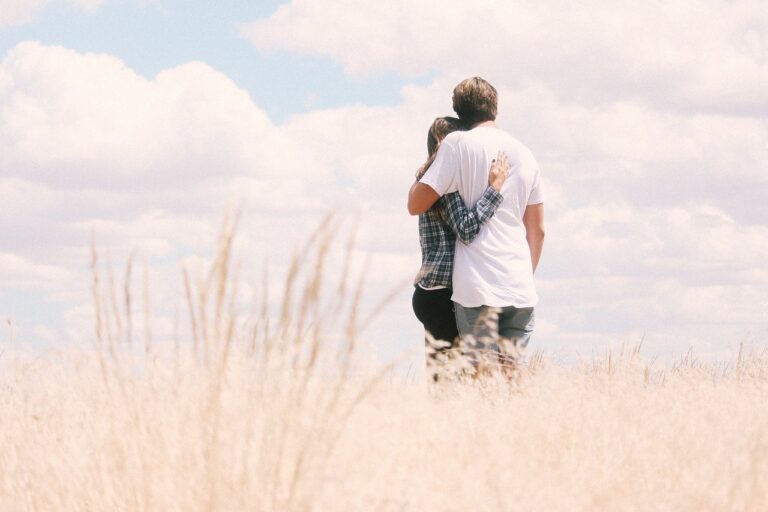 A hugging couple discussing when can i change my last name after marriage